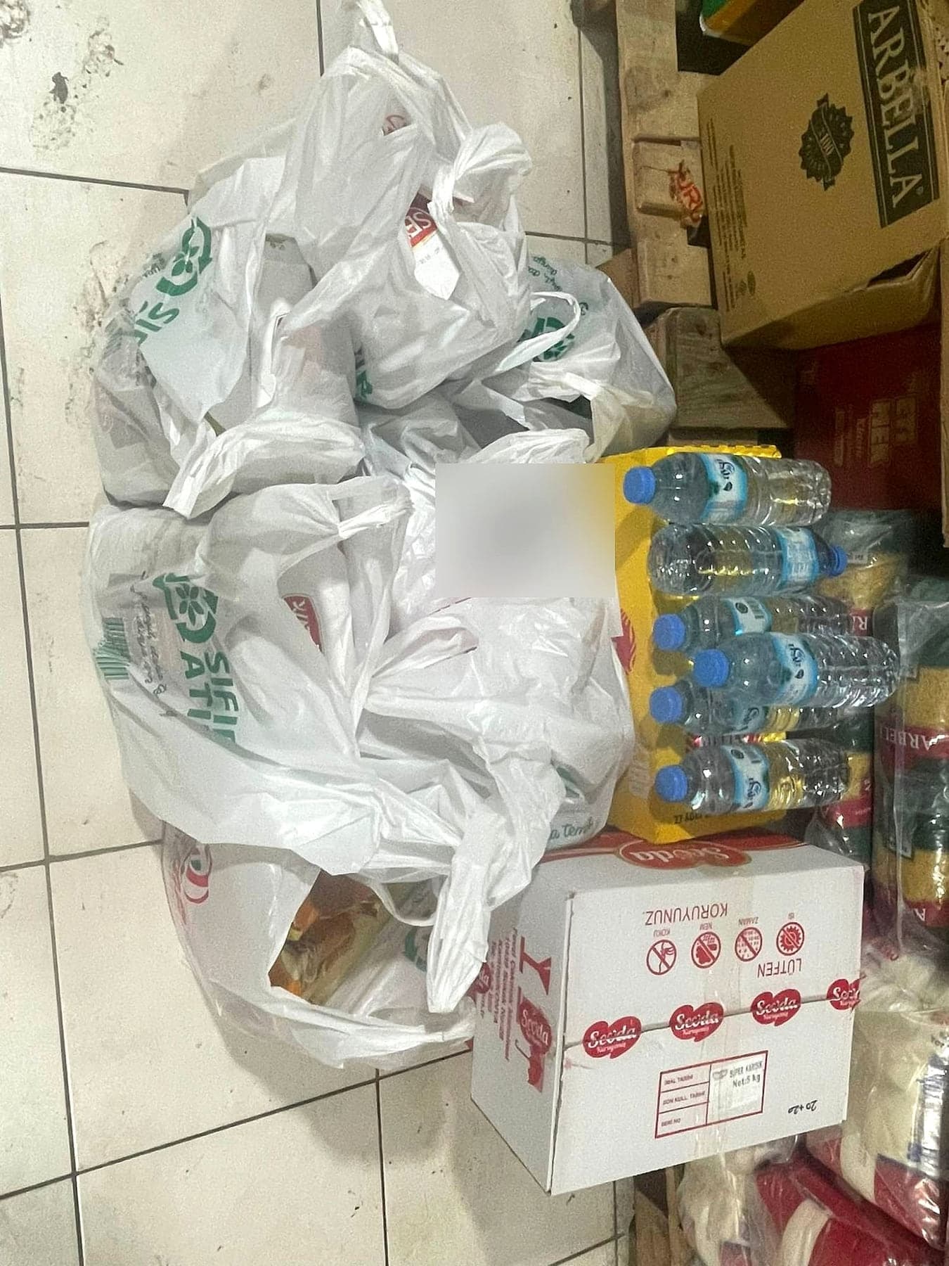 Depoda aile aile ayrılmış gıda poşetleri, su ve kuru gıda kutuları